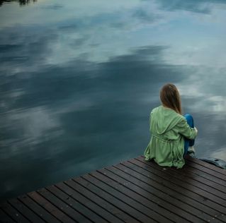 Woman Sitting on Wooden Planks